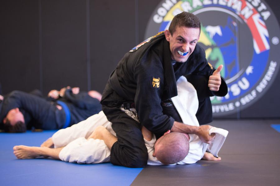 A Just1 coach smiling during a Brazilian jiu-jitsu class